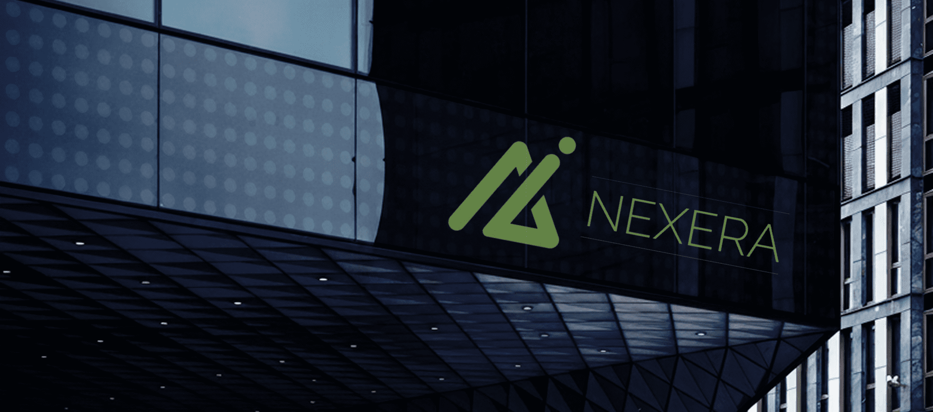 Glass building facade with Nexera logo displayed.